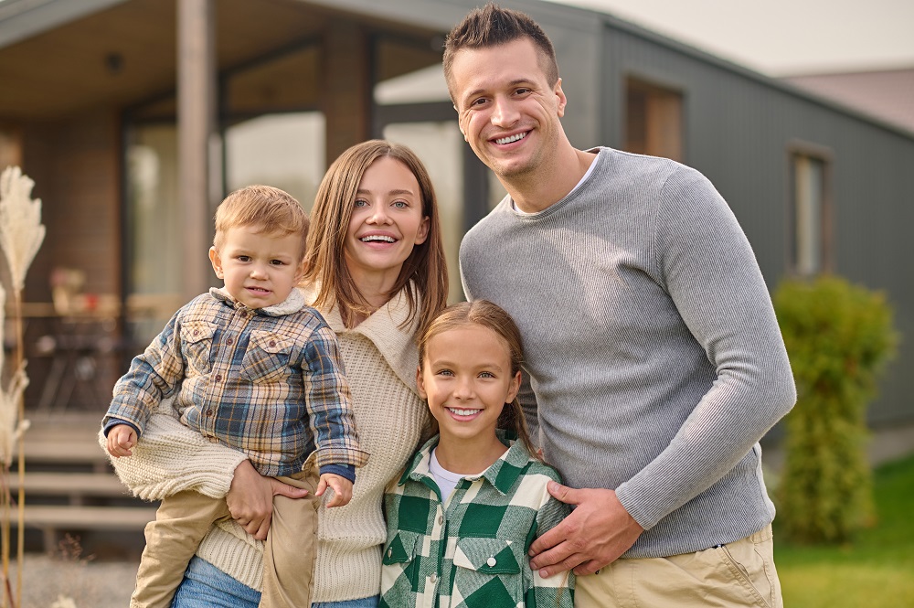 Юлия/Аналитика/Бахтизин2/happy-people-young-beautiful-woman-with-little-boy-attractive-man-and-long-haired-school-age-girl-in-casual-clothes-hugging-joyful-looking-at-camera-standing-near-house.jpg